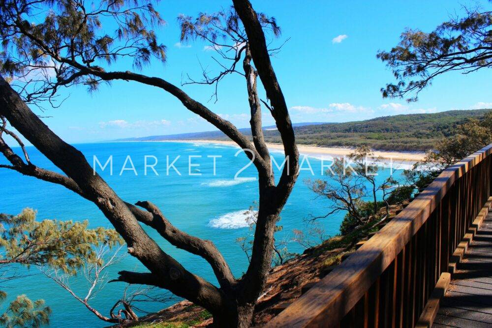 a view of the ocean from a wooden walkway