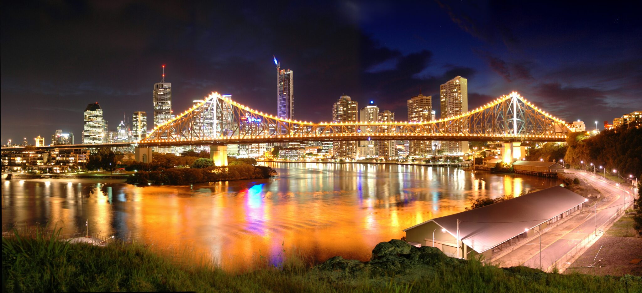 lighted bridge over water during night time