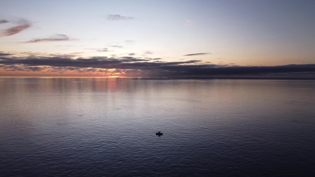 Aerial View Over Boat In The Ocean At Sunset
