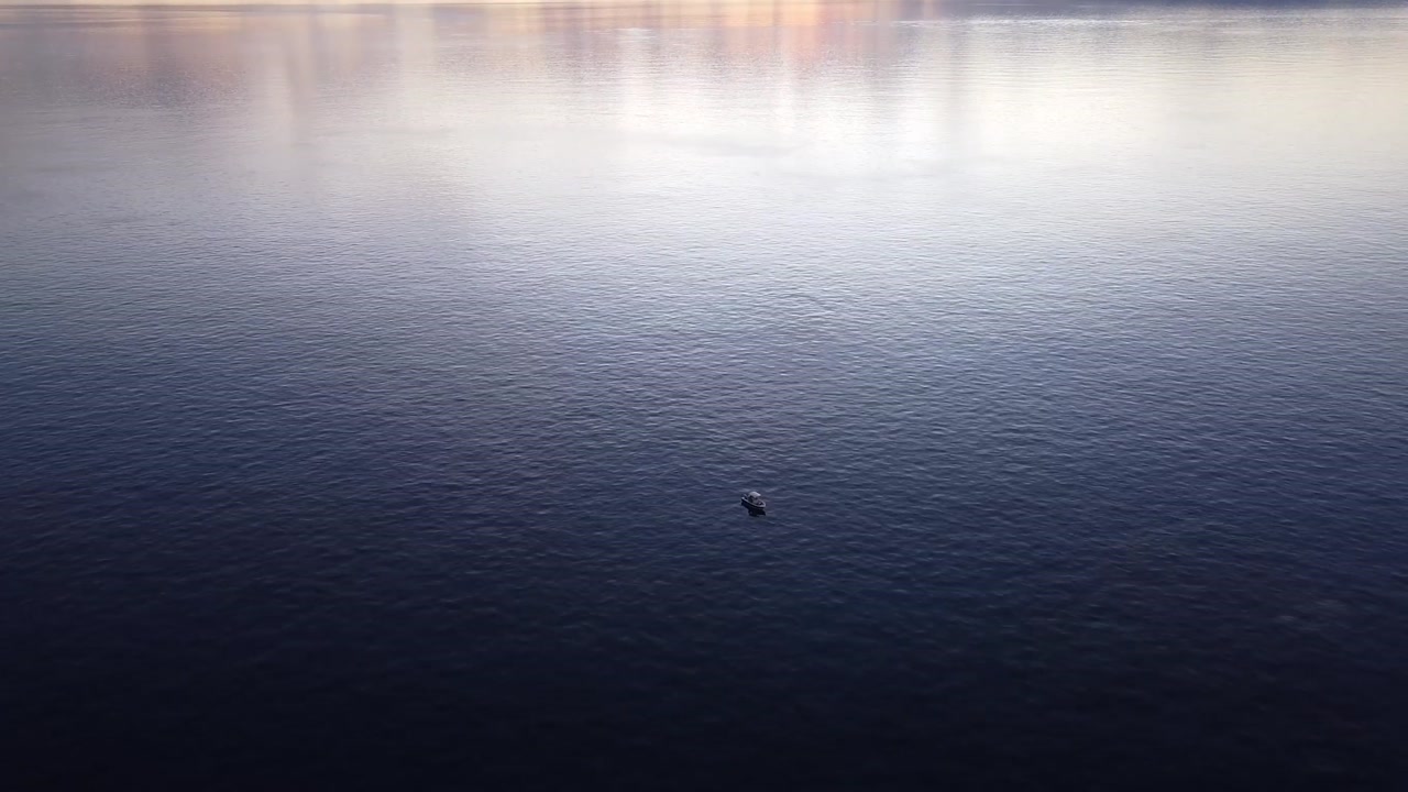 Aerial View Over Boat In The Ocean At Sunset