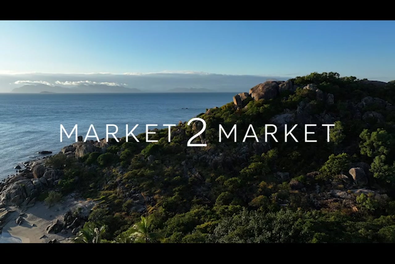 Aerial footage over rocky coastline of Horseshoe Bay, Bowen