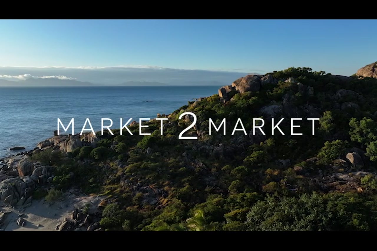 Aerial footage over rocky coastline of Horseshoe Bay, Bowen