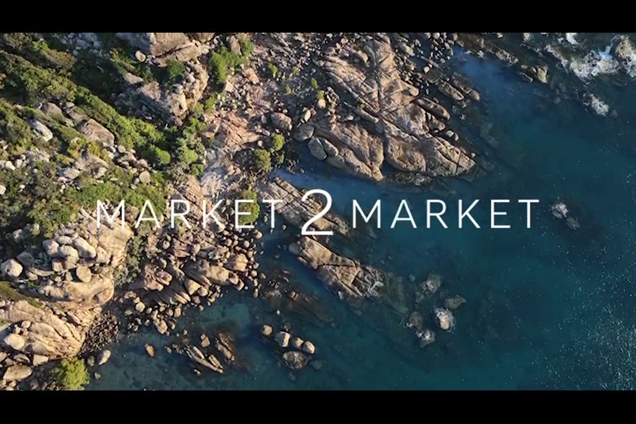 Aerial footage over rocky coastline of Horseshoe Bay, Bowen