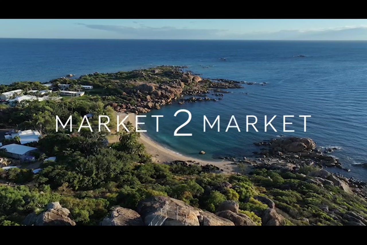 Aerial footage of Horseshoe Bay and rocky headlands, Bowen