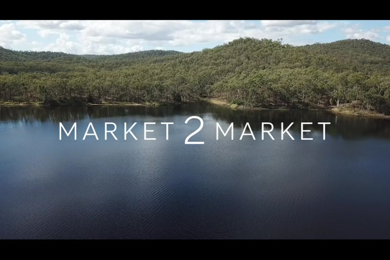Aerial footage over a lake with lush vegetation surrounding it