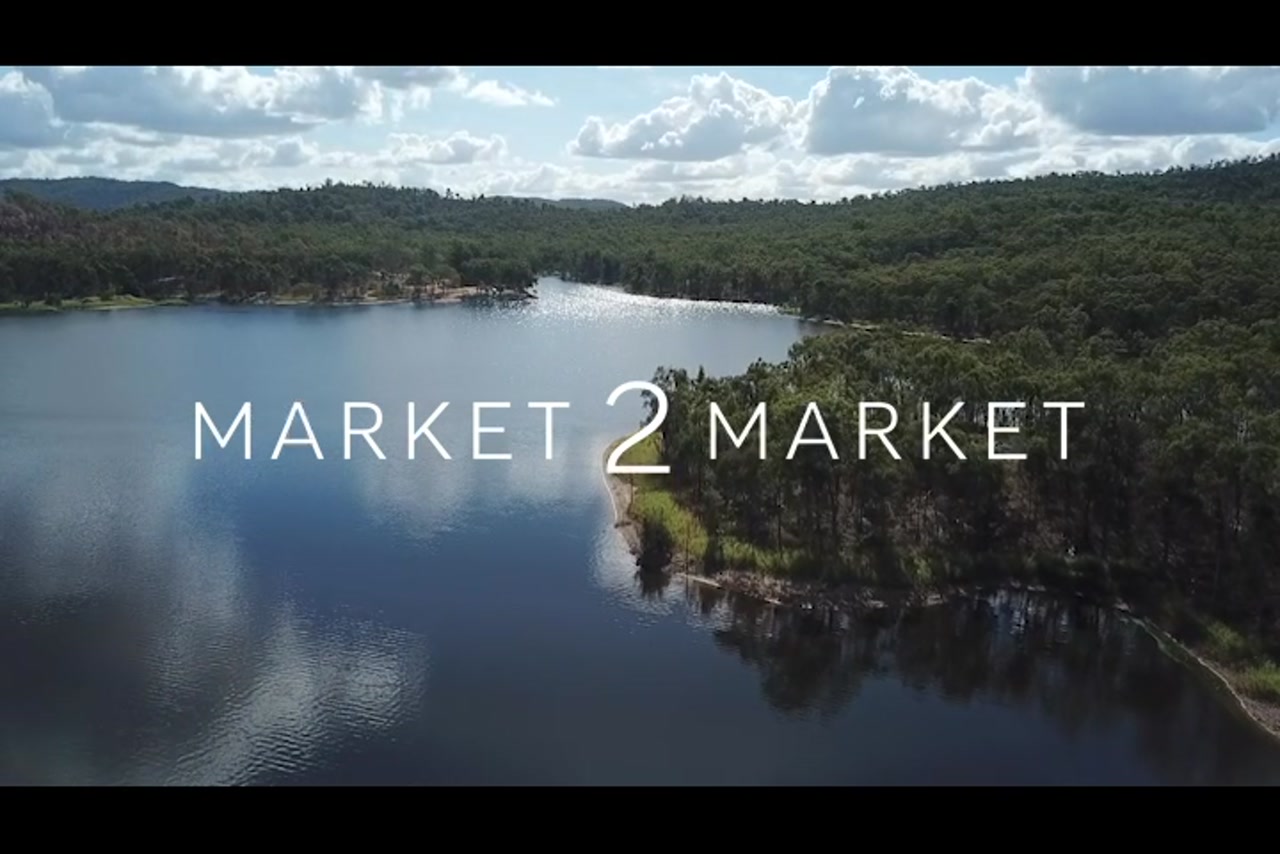 Aerial footage over a lake with lush vegetation surrounding it