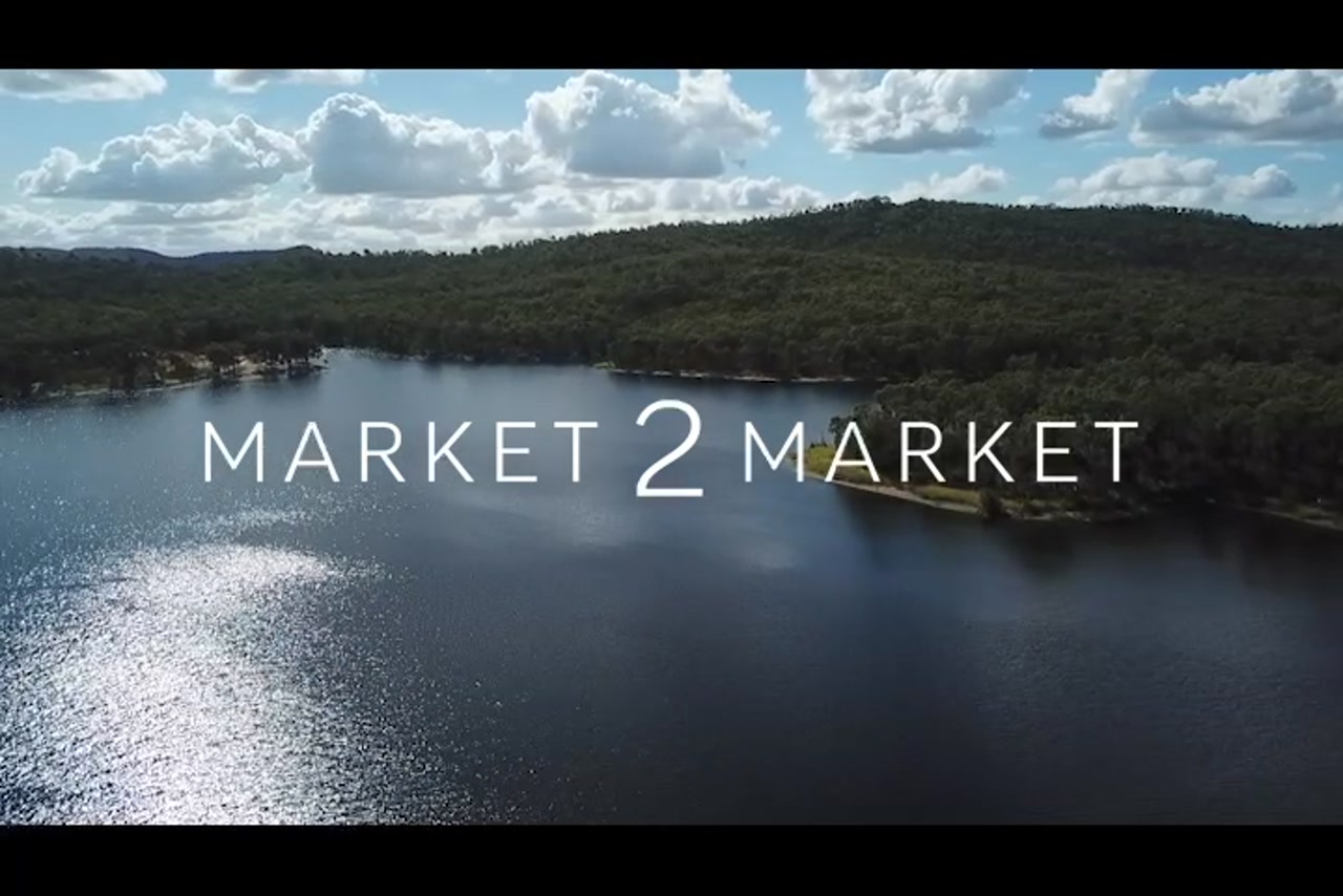 Aerial footage over a lake with lush vegetation surrounding it