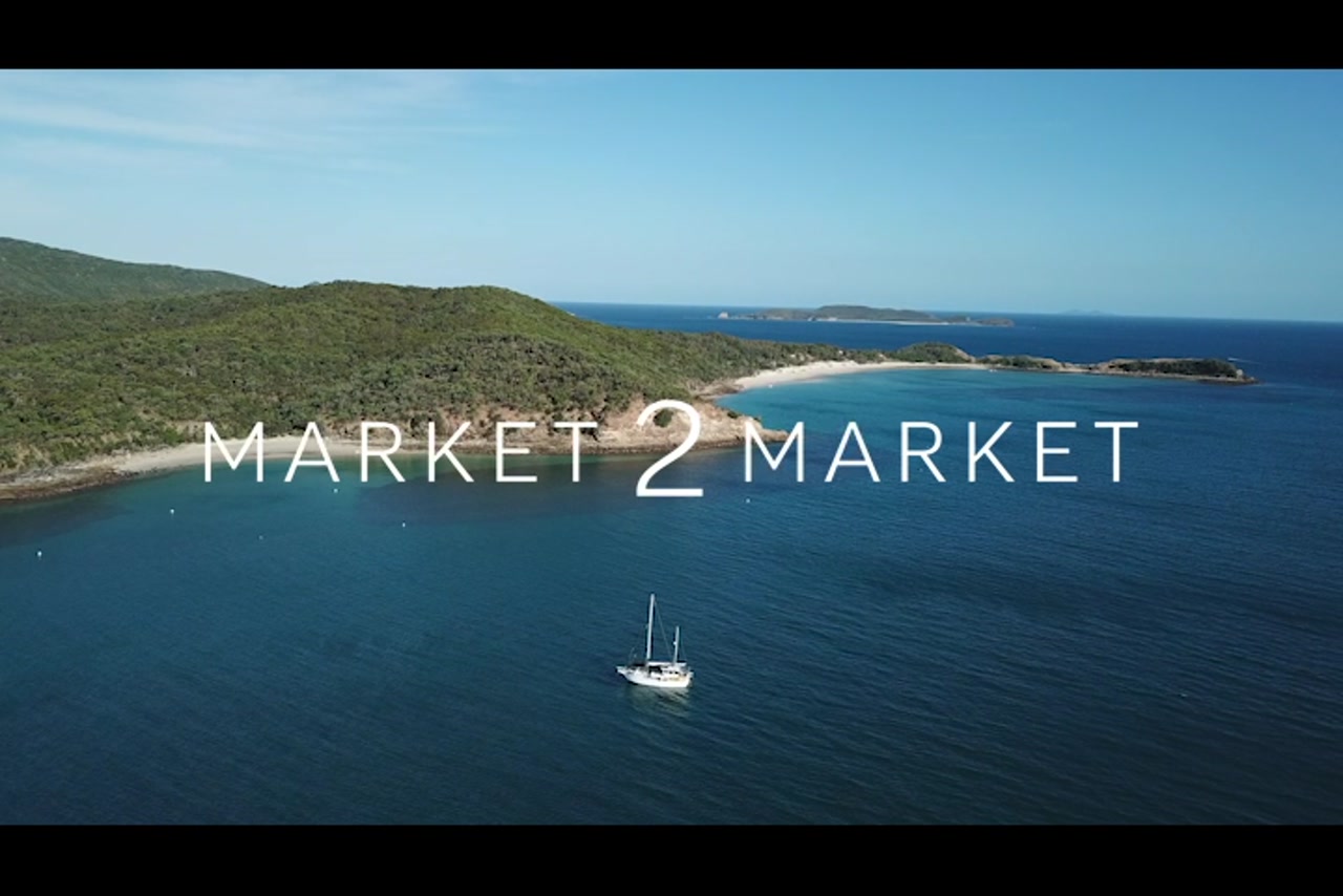 Aerial footage over Great Keppel Island with a Yacht in the ocean