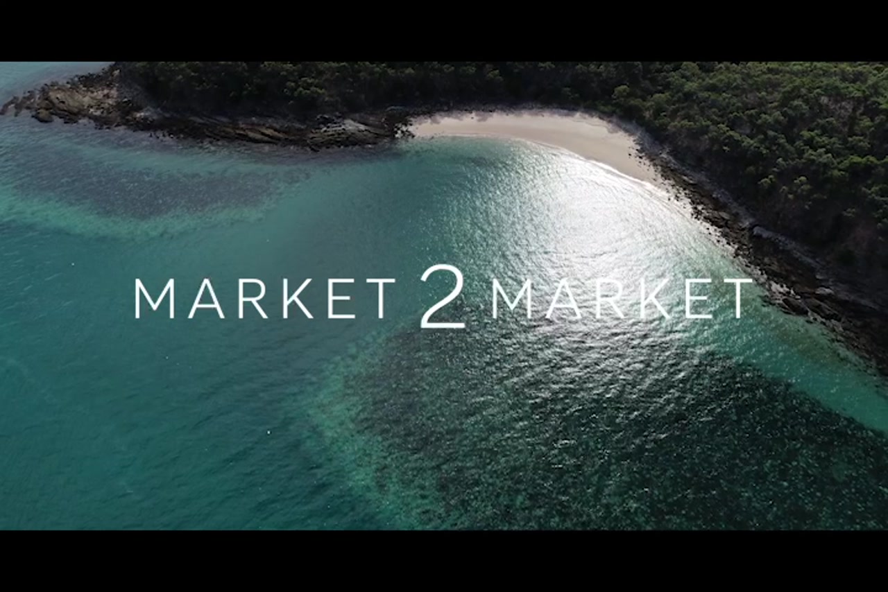 Aerial footage over reef and small beach on Great Keppel Island
