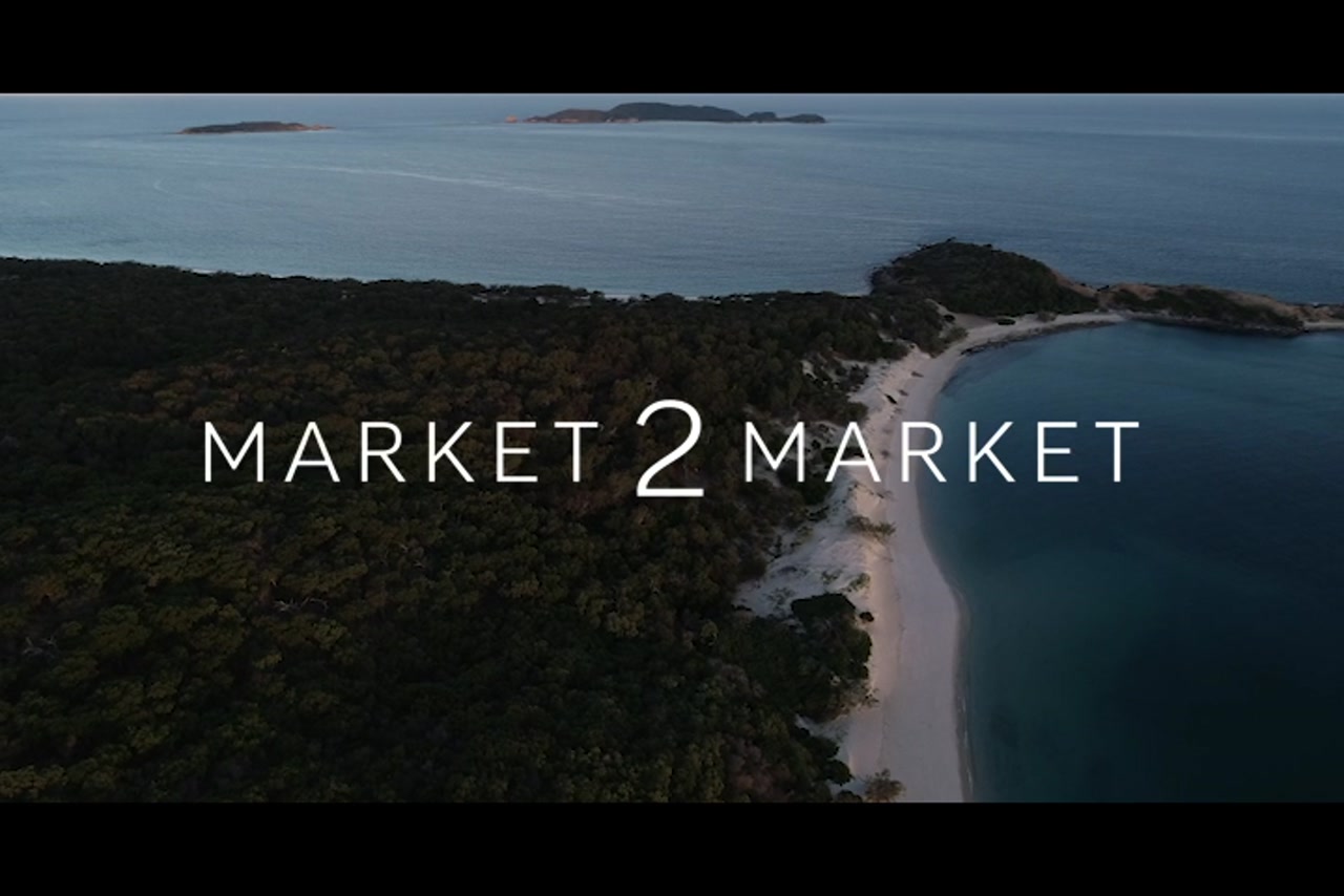 Aerial footage of coastline and beaches of Great Keppel Island at dusk