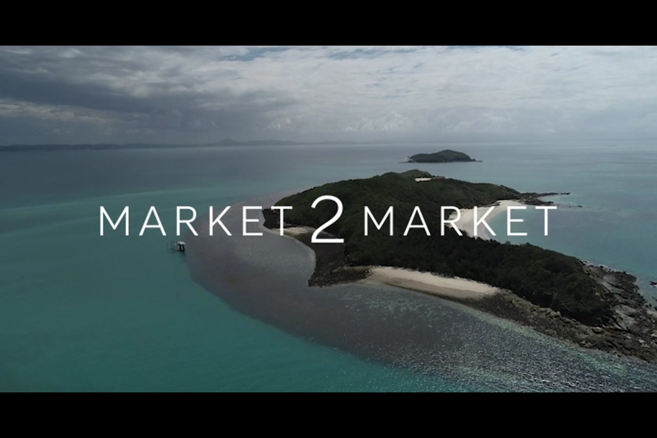 Aerial footage of reef surrounding a small island in the Great Keppel region