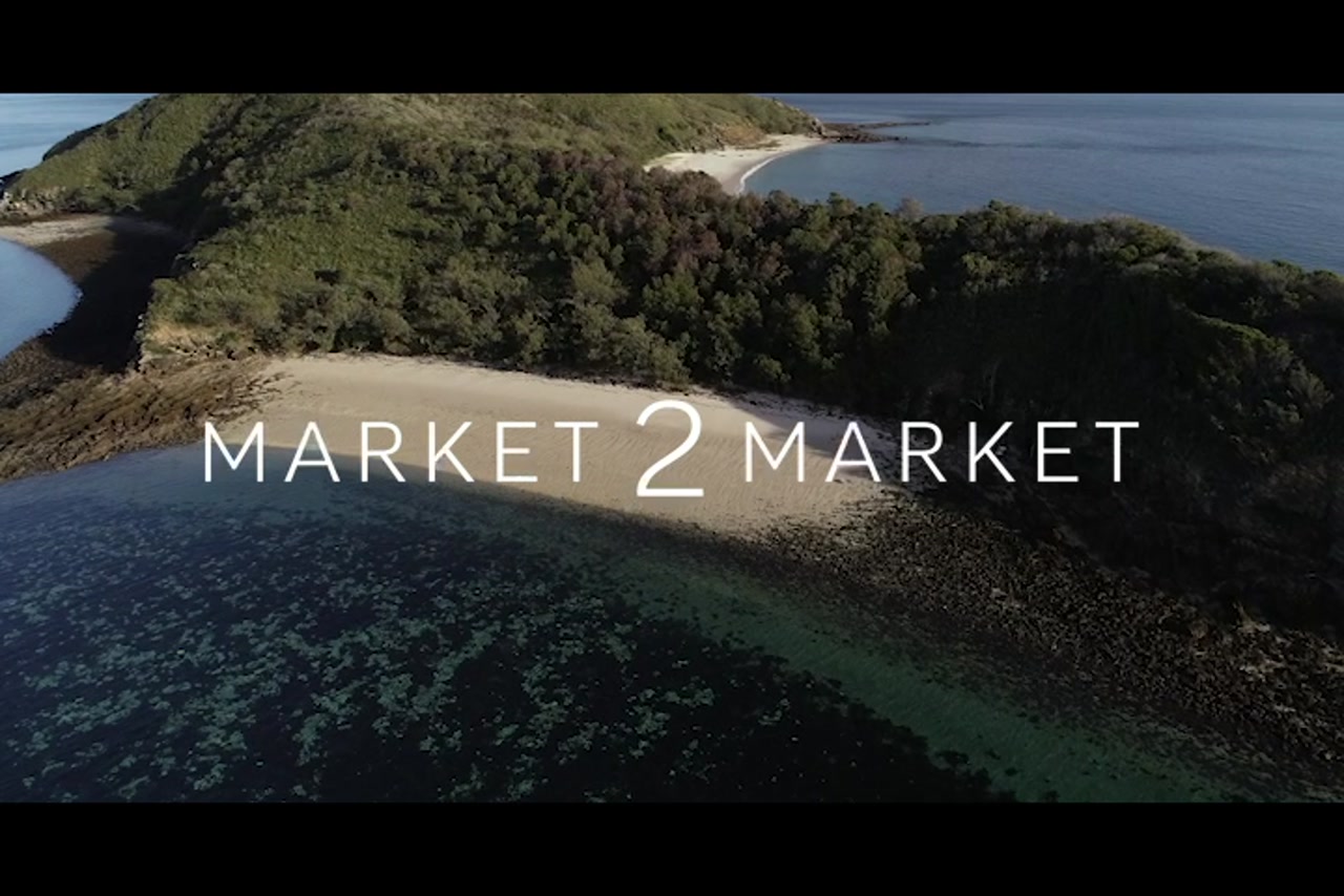 Aerial footage over reefs and small island in the Keppel region