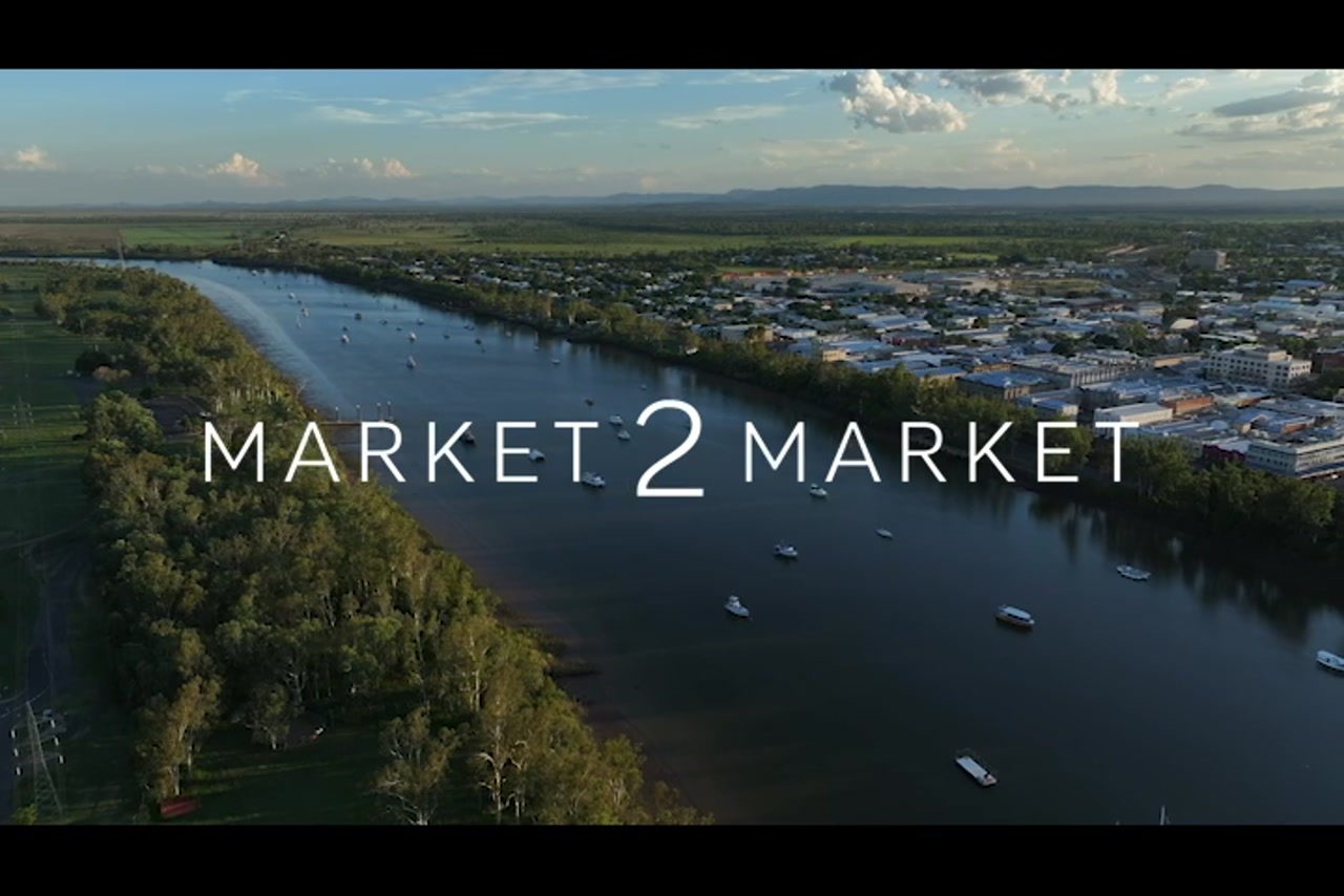Aerial footage over Fitzroy River, Rockhampton CBD, at dusk