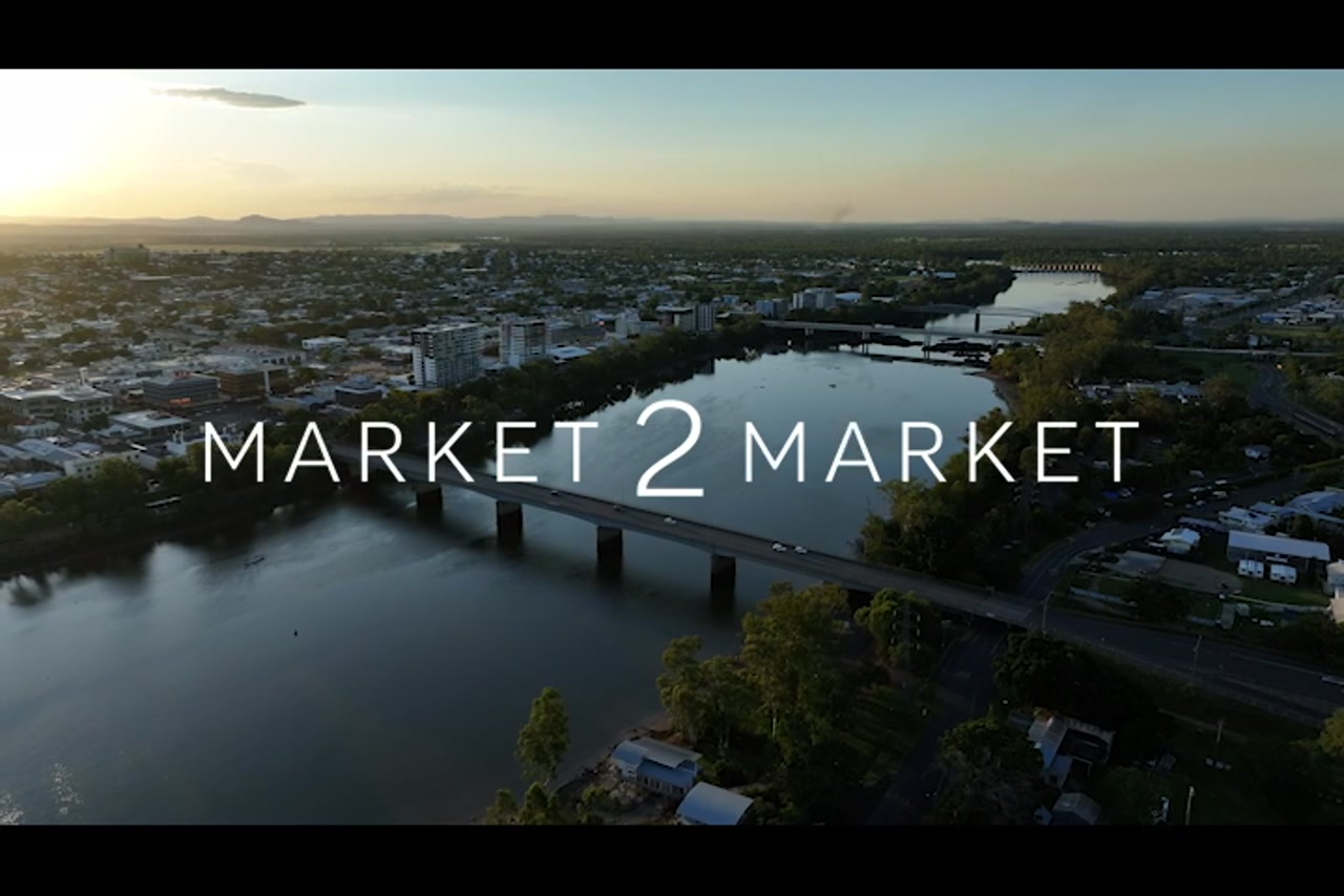 Aerial footage over Fitzroy River, Rockhampton CBD, at dusk