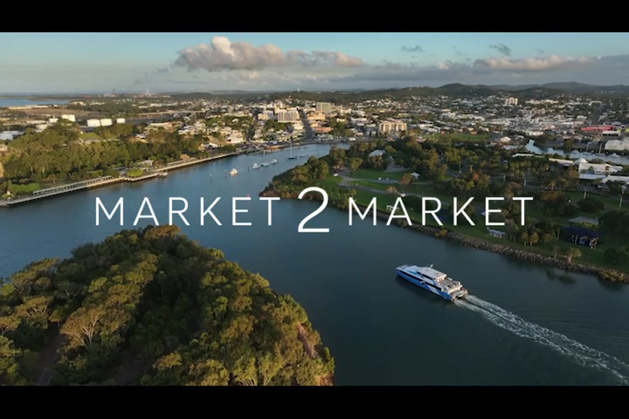 Aerial footage of ferry traveling past Spinnaker Park Point, Gladstone