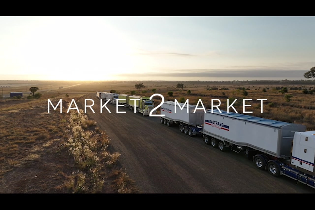 Aerial footage at over freight trucks parked in outback setting at dusk