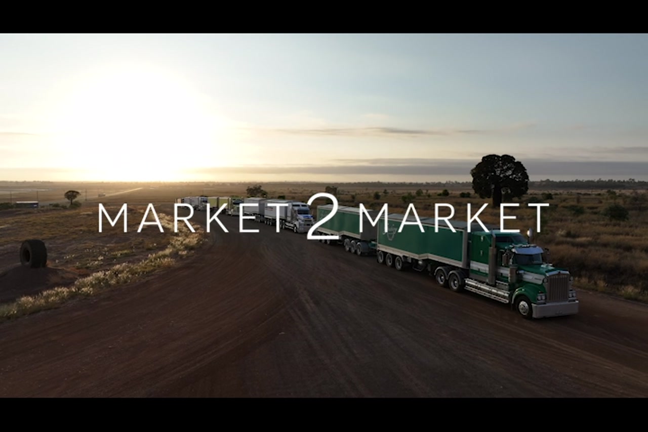 Aerial footage at over freight trucks parked in outback setting at dusk