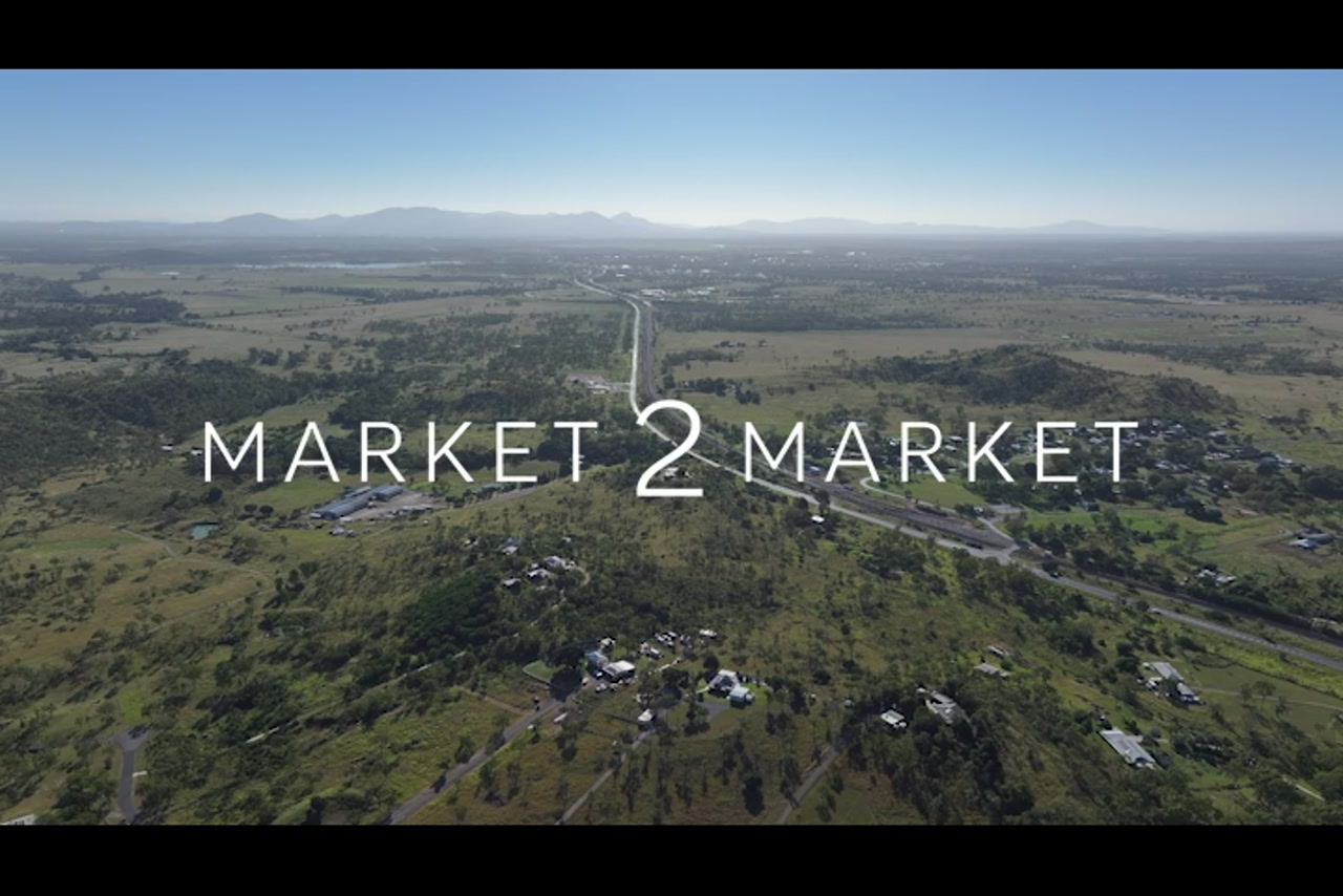 Aerial footage of rural residential area near highway and trainline