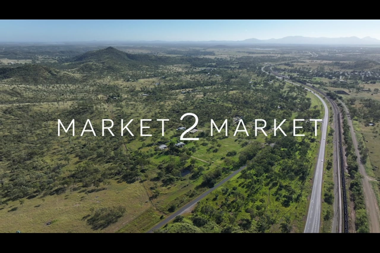 Aerial footage over highway and train line in a regional area of Central Queensland