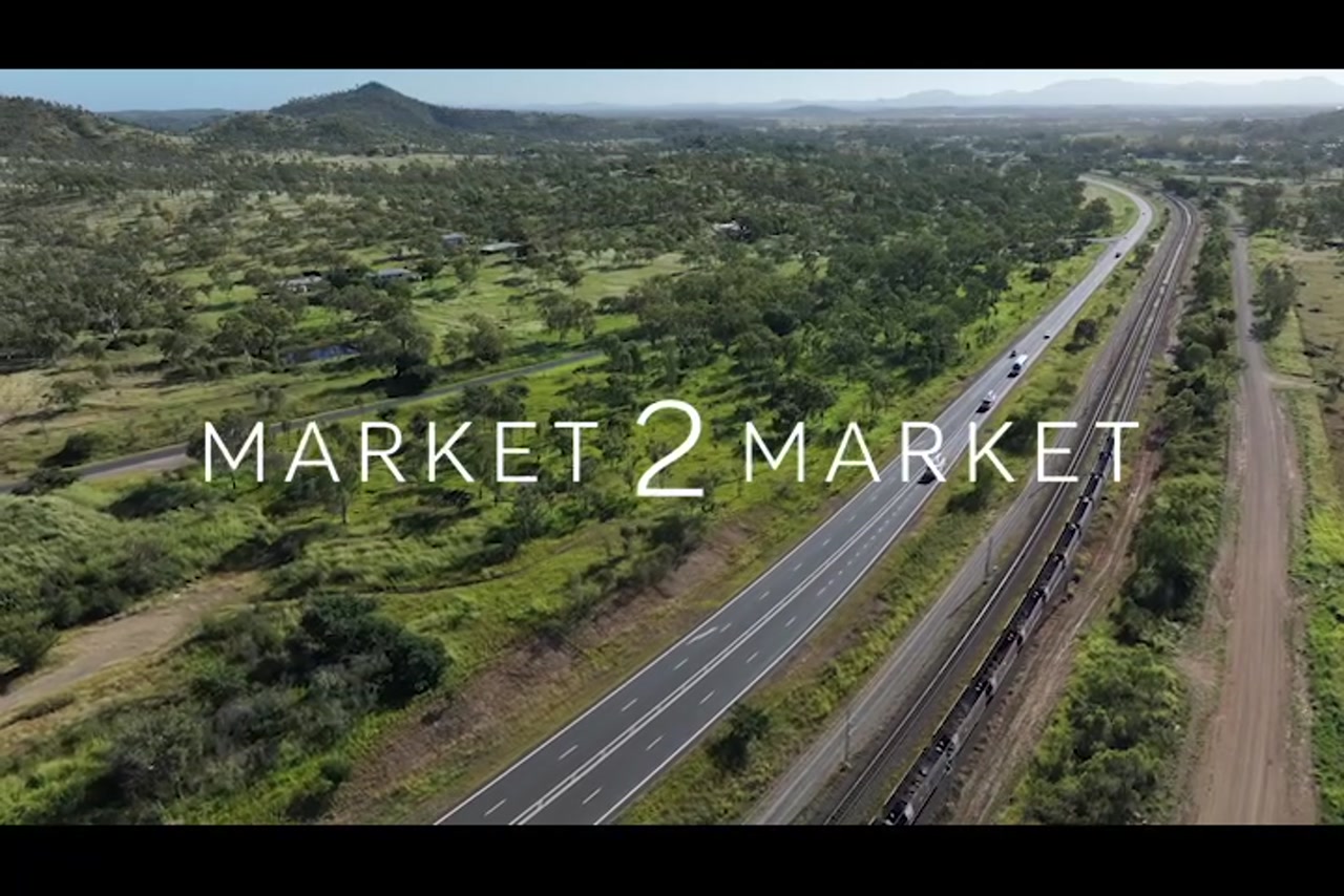 Aerial footage over highway and train line in a regional area of Central Queensland