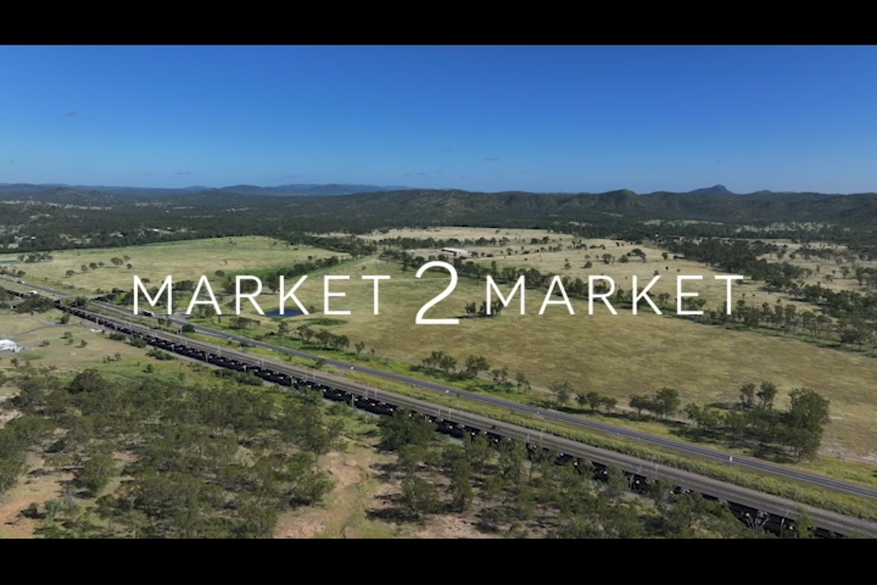 Aerial footage over highway and train line in a regional area of Central Queensland