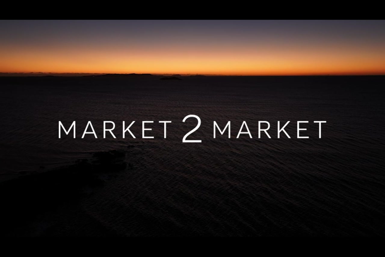 Aerial footage of ocean silhouetted at dusk